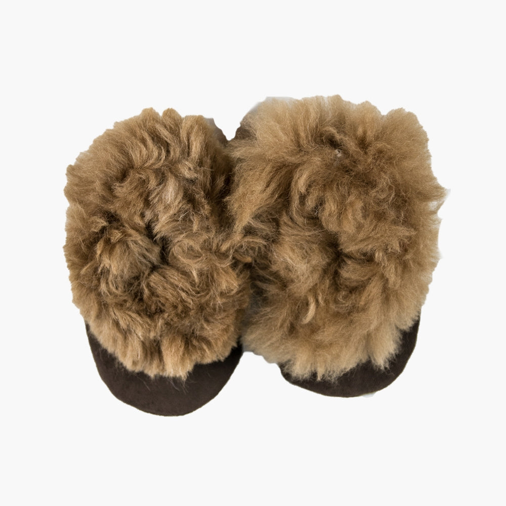 A pair of brown children's alpaca fur slippers laid out in a flat position.