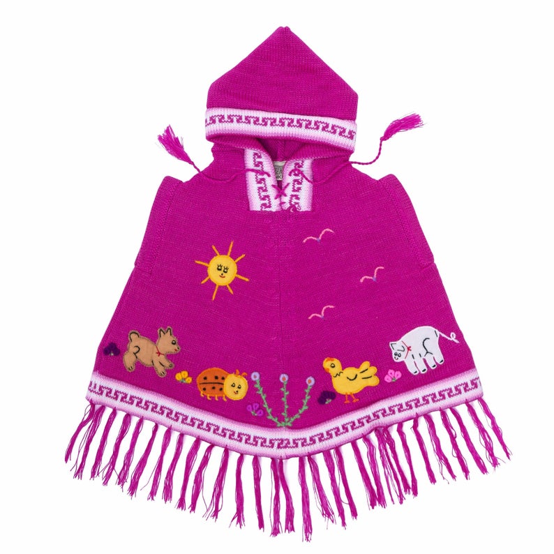 A pink children's poncho with hood, featuring a zipper and decorative animal patterns.